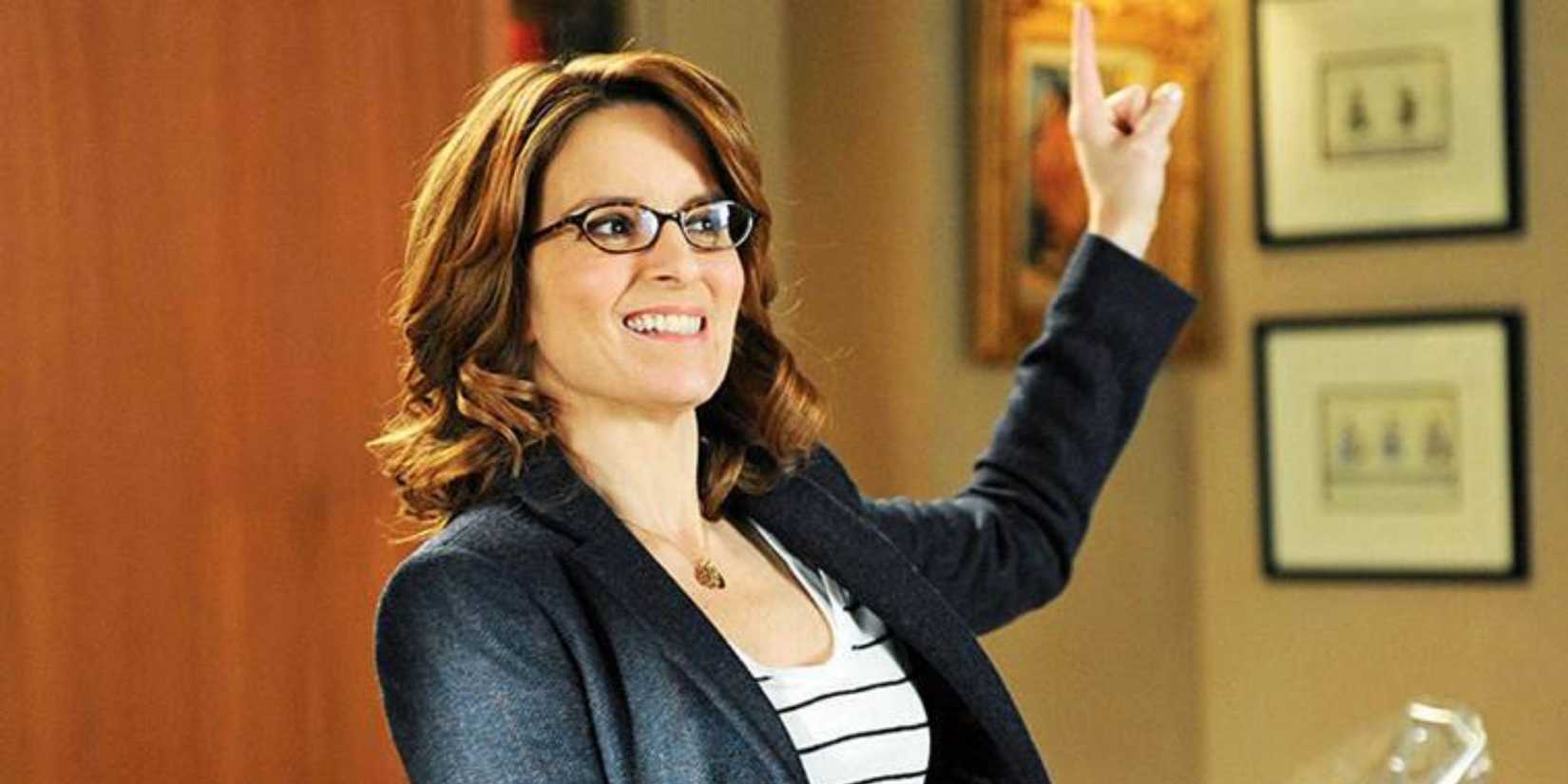 Liz Lemon pointing her finger up and smiling in 30 Rock.