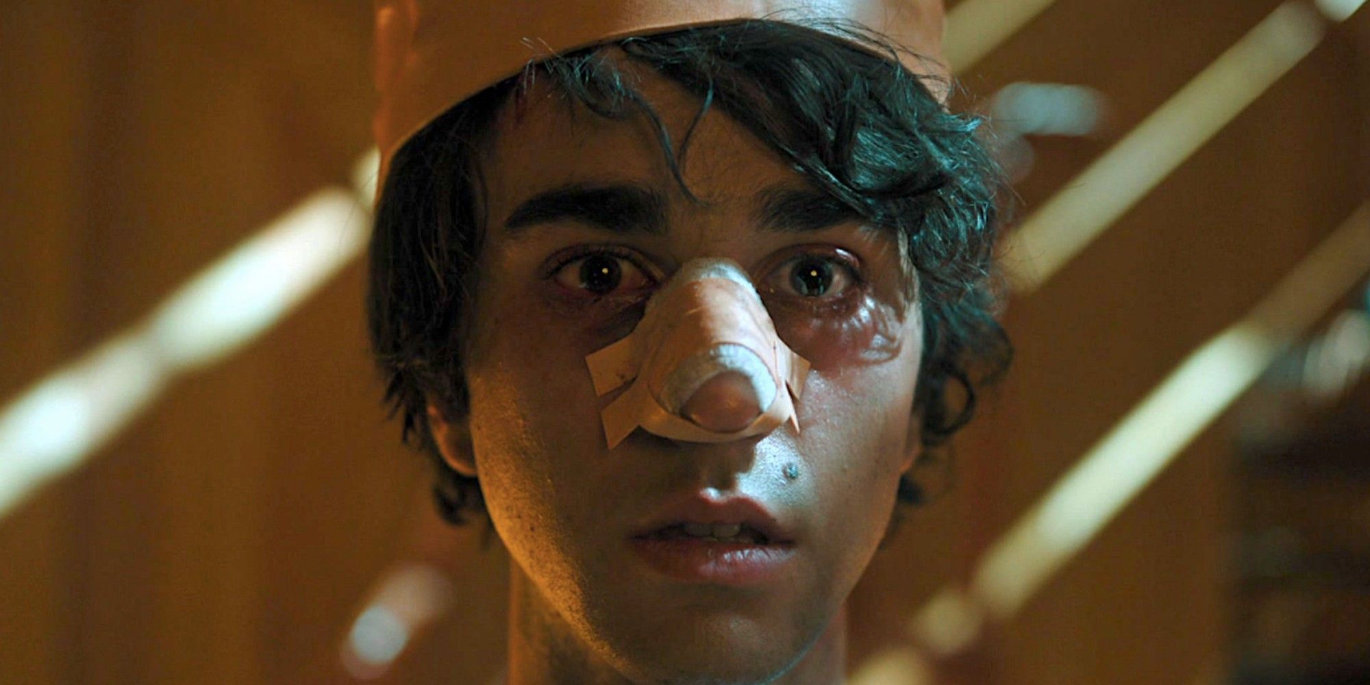 Peter wearing a paper crown looking shocked in Hereditary