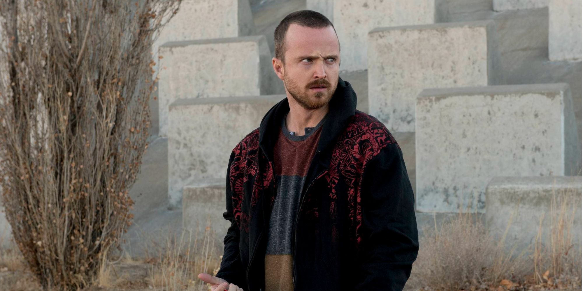 Aaron Paul as Jesse Pinkman in Breaking Bad standing on the street looking angry