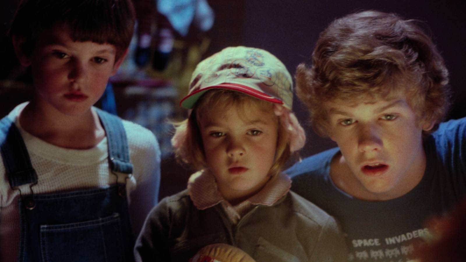 Henry Thomas, Drew Barrymore and  Robert MacNaughton looking at E.T. in E.T. The Extra-Terrestial