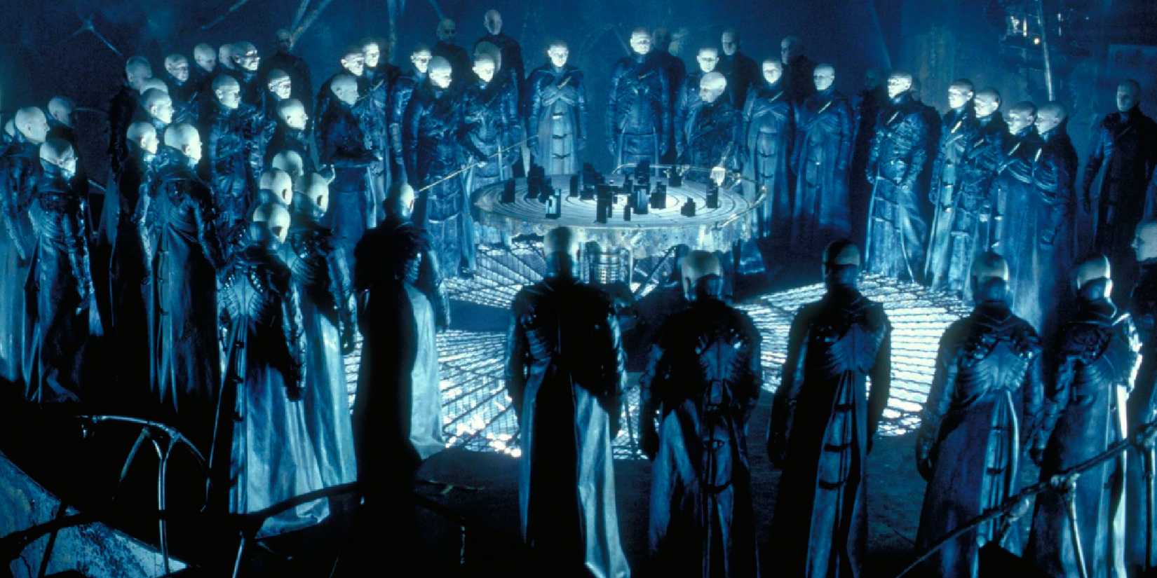 A group of white-faced people in a circle in Dark City 