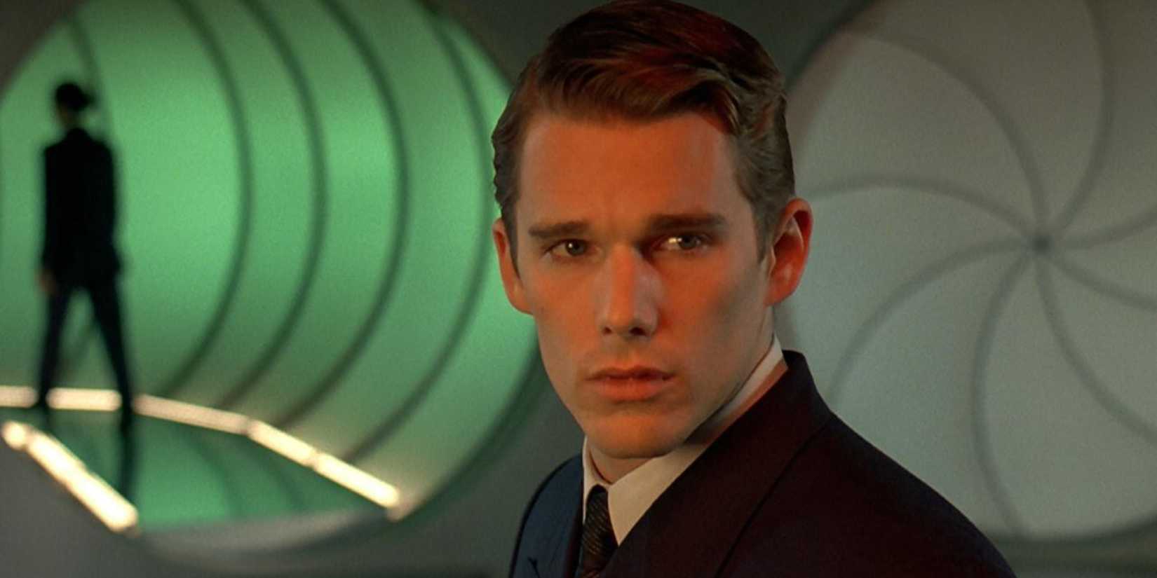 Ethan Hawke in a business suit inside green tunnels looking perplexed in Gattaca.