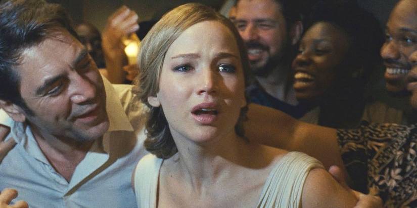 Mother, played by Jennifer Lawrence, looks terrified as smiling people crowd around her in Mother!