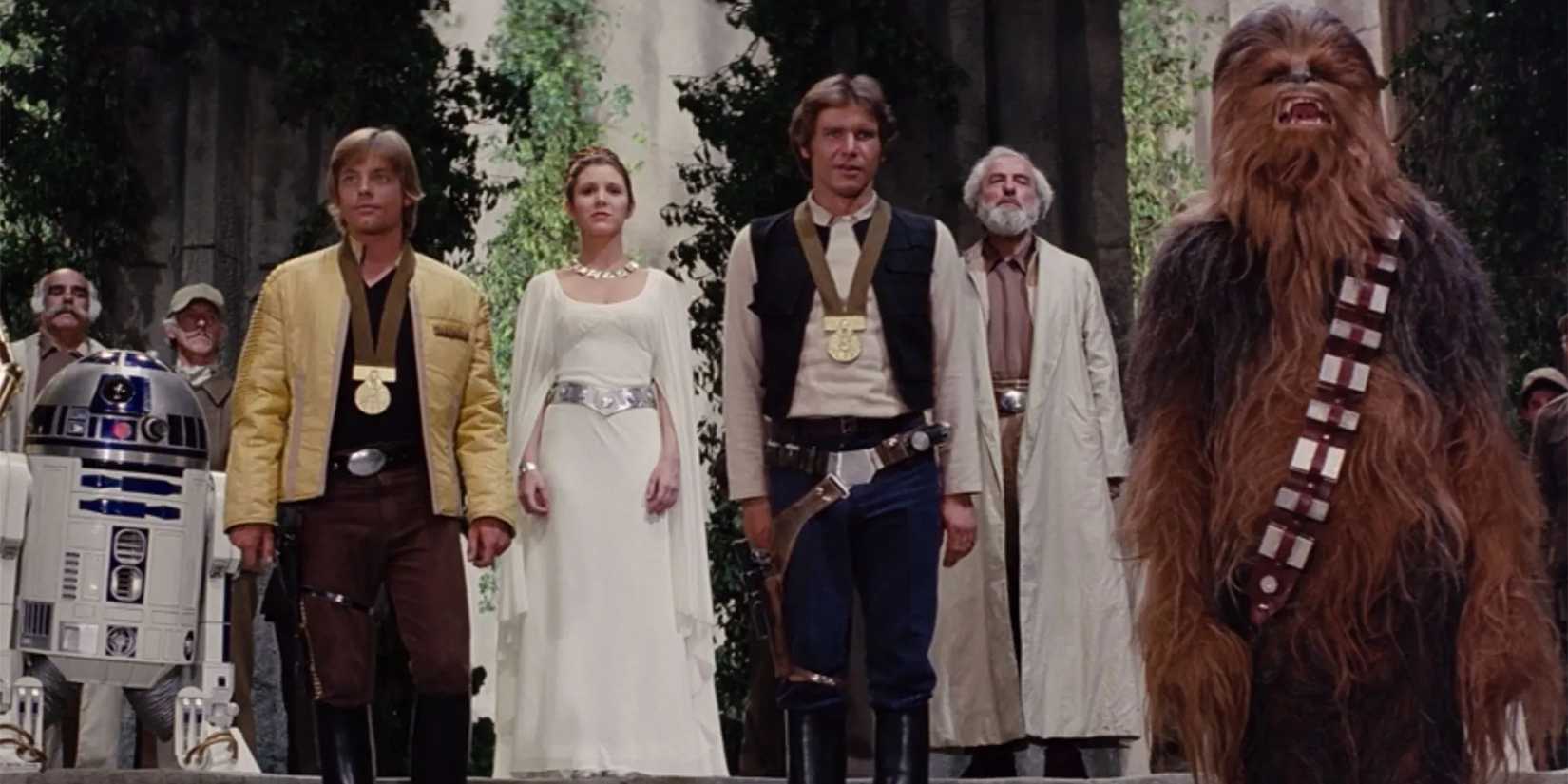 R2-D2, Luke Skywalker, Princess Leia, Han Solo, and Chewbacca pose during the ending of Star Wars.