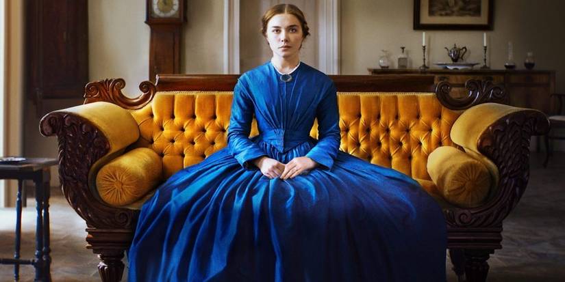 Florence Pugh as Katherine Lester sitting on a couch and looking at the camera in Lady Macbeth