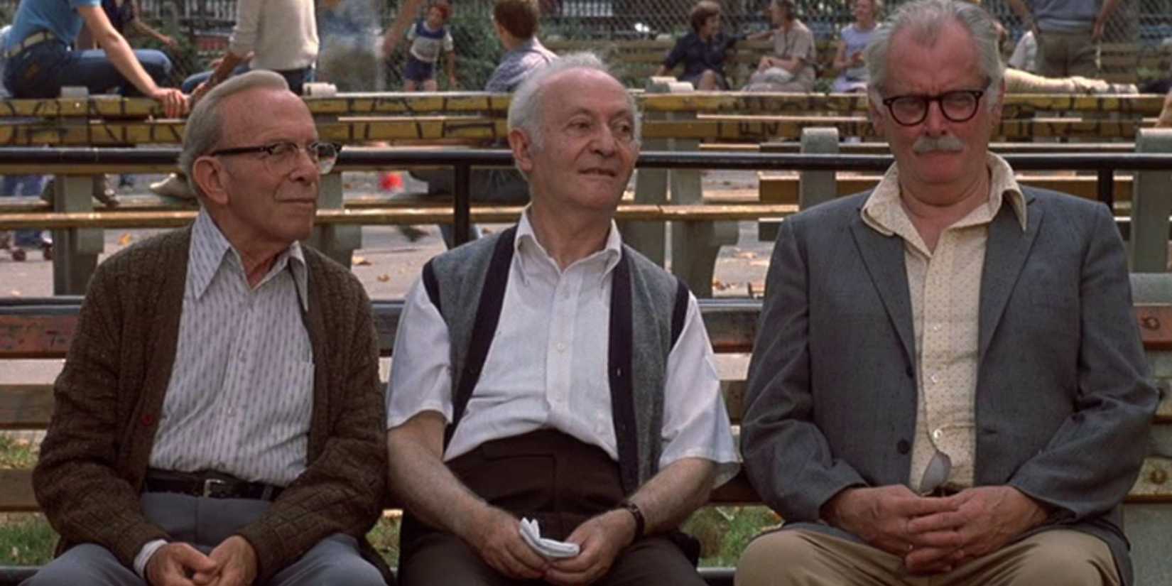 Three senior citizens sitting on a bench