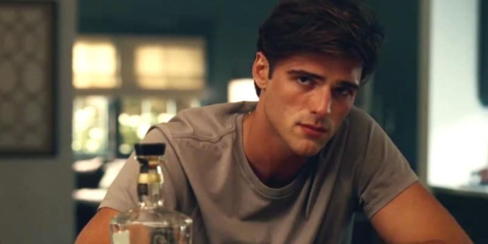 A man stares at the camera as he sits at the bar