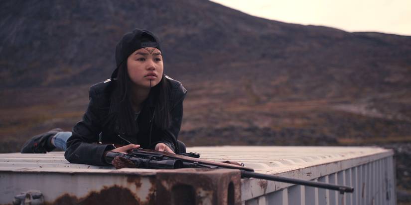 Girl holds a rifle in Canada in slash/back 