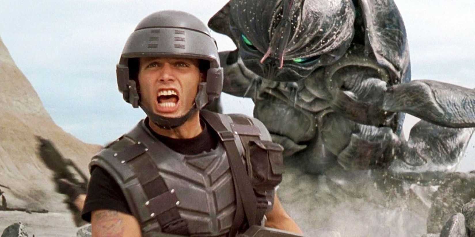 Casper Van Dien, as Johnny RIco, running from a giant alien bug in Starship Troopers