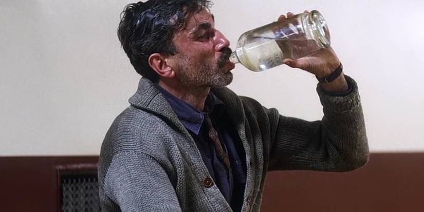Daniel Day-Lewis as Daniel Plainview drinking in There Will Be Blood