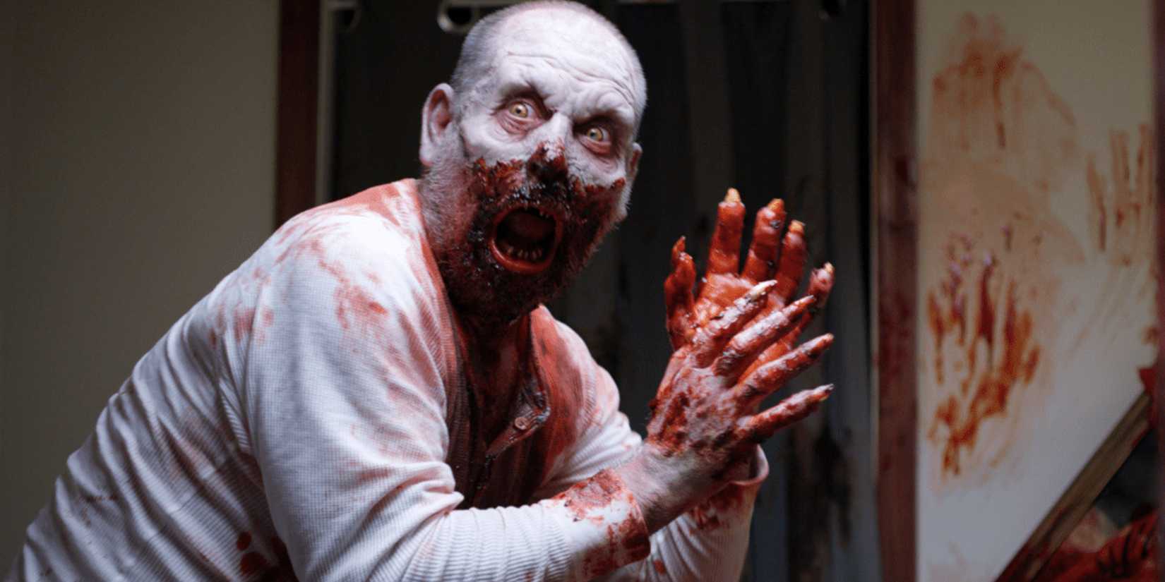 A man with pale white skin has blood all over his mouth and hands and looks surprised in Uncle Peckerhead.