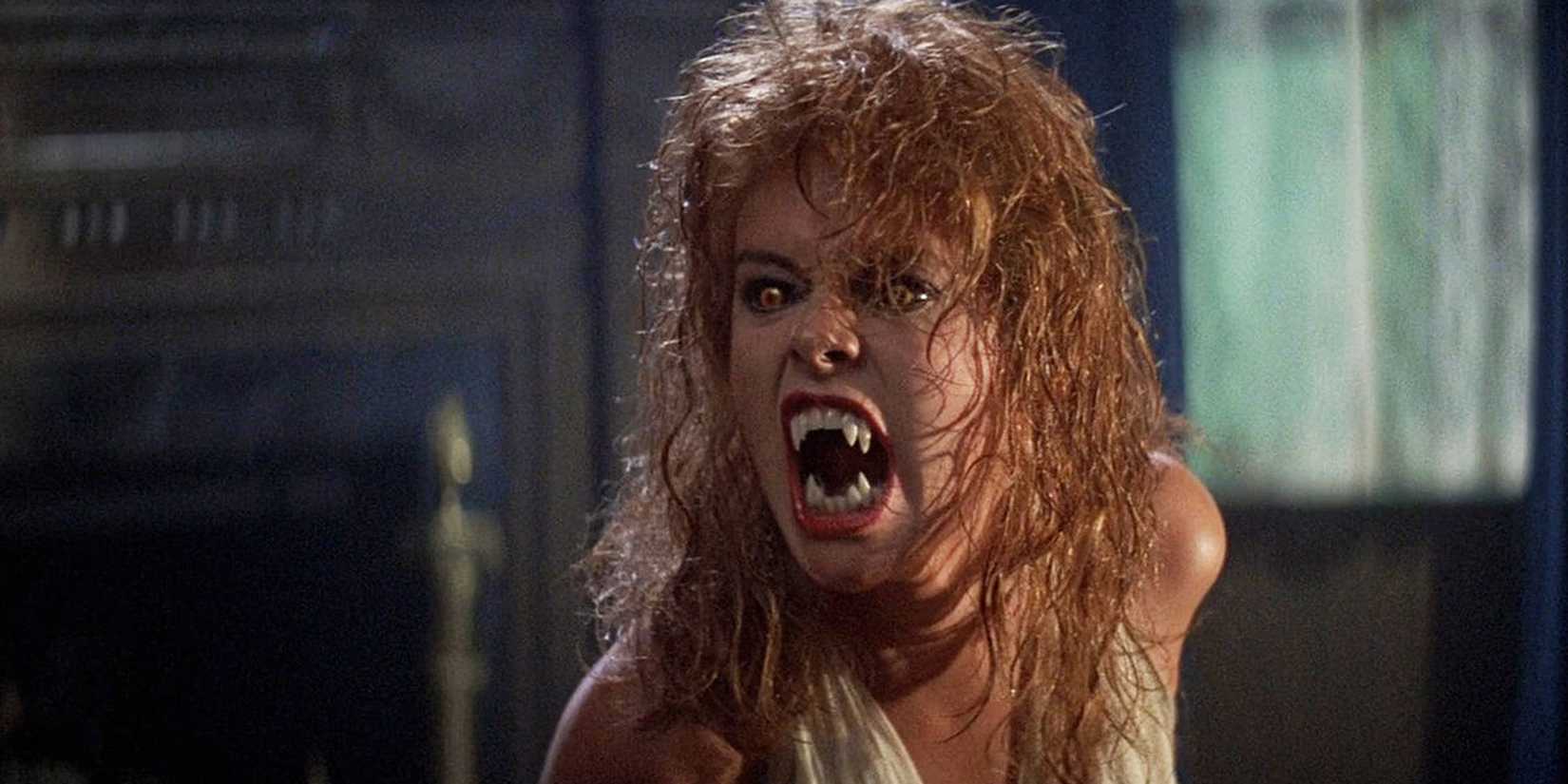 a vampire woman with wild red hair, growling at someone unseen