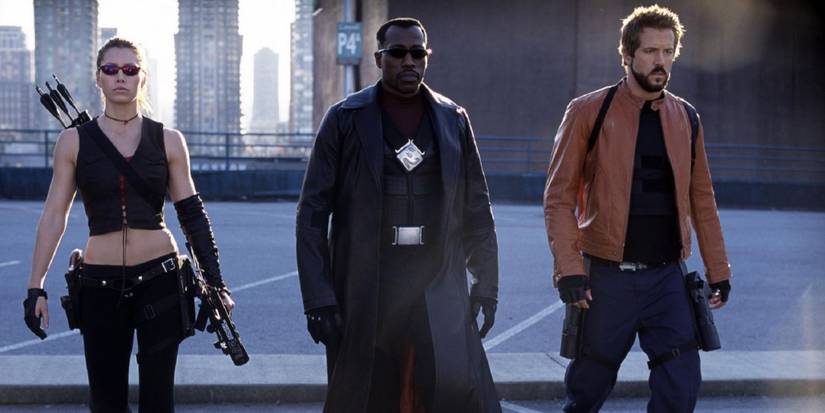 Abigail Whistler, Blade, and Hannibal King walk with loaded weapons on a street in Blade: Trinity