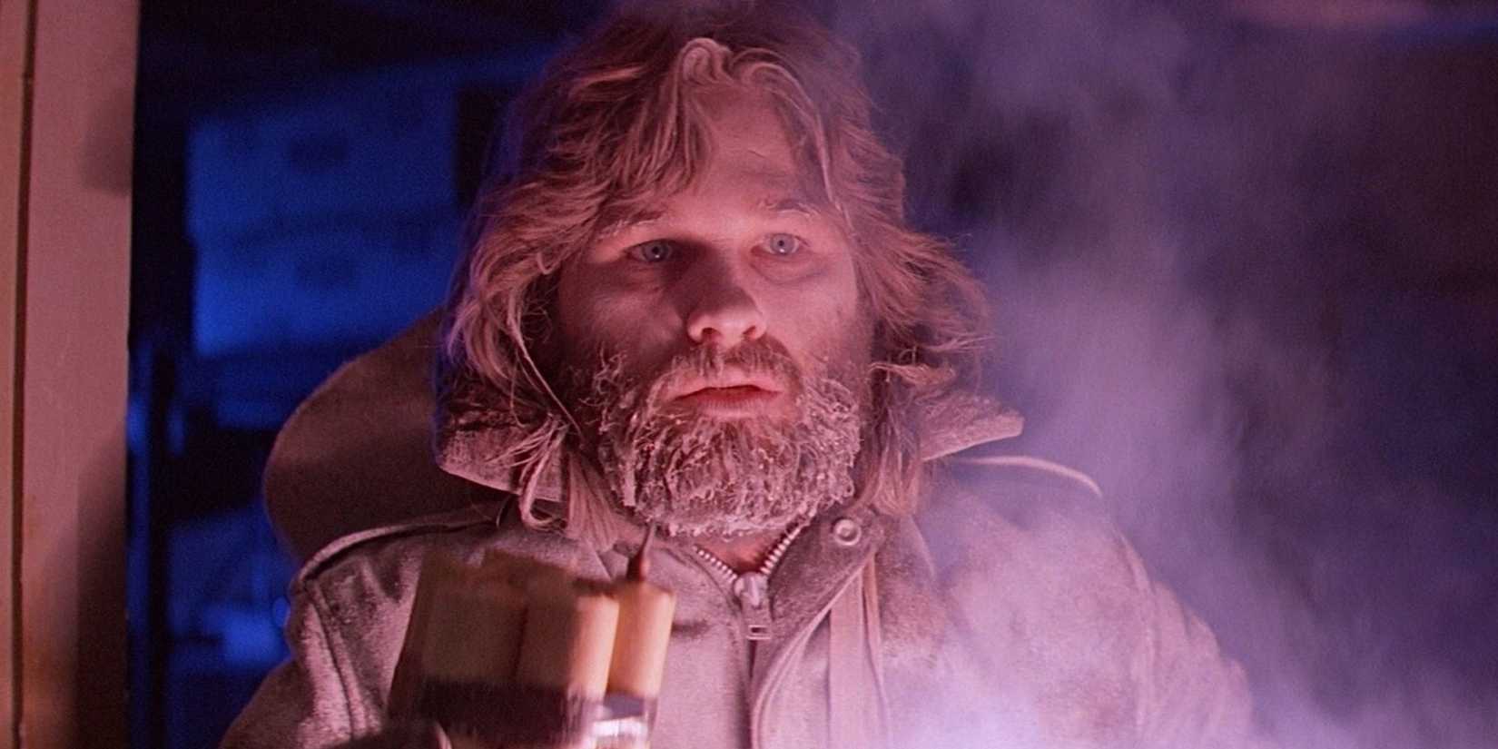 R. J. MacReady holding explosives while looking scared in The Thing.