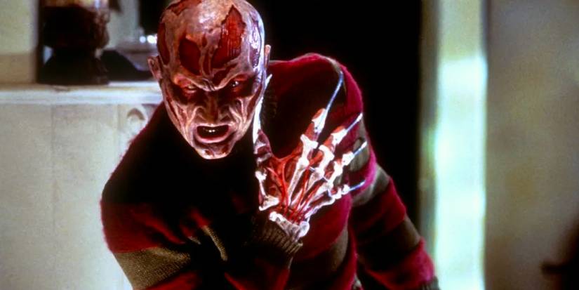 Close up of Freddy Krueger (Robert Englund) holding his shoulder in Wes Craven's New Nightmare