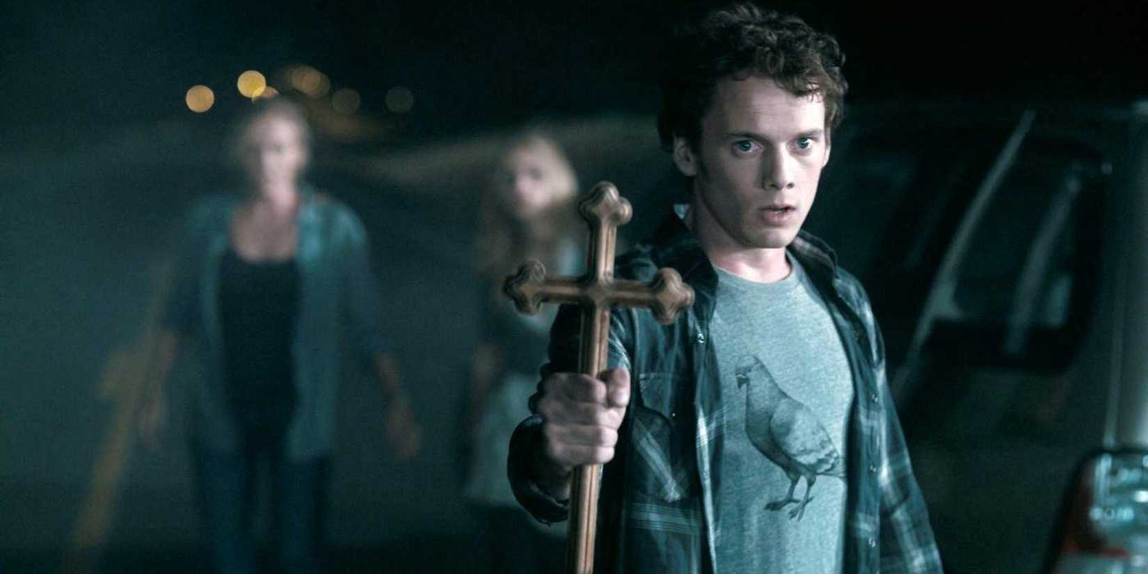 Anton Yelchin as Charley holding a crucifix in Fright Night