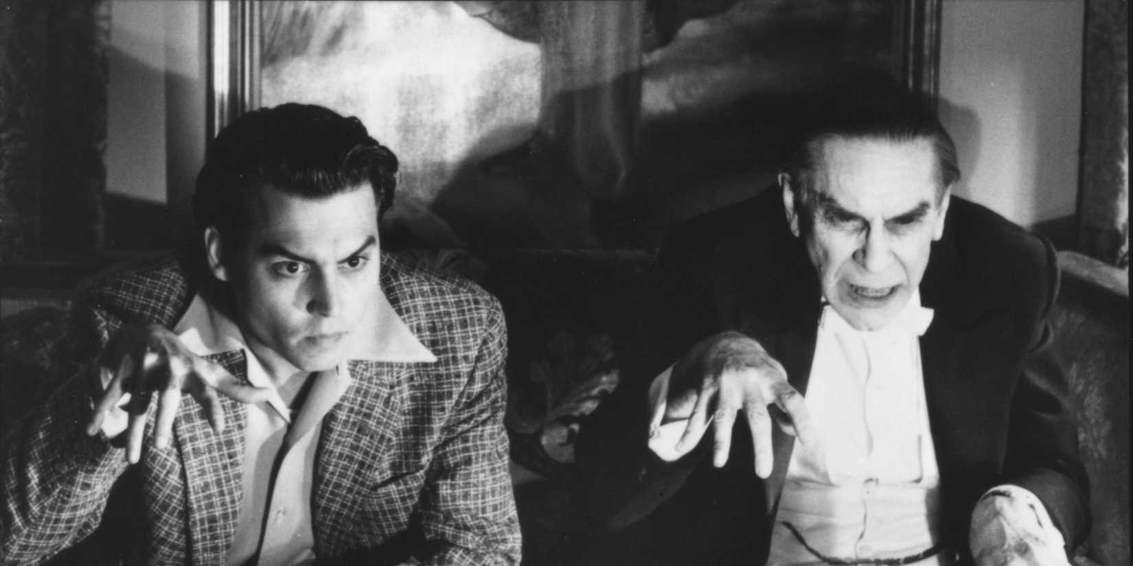Two guys are posing as Draculas while watching TV