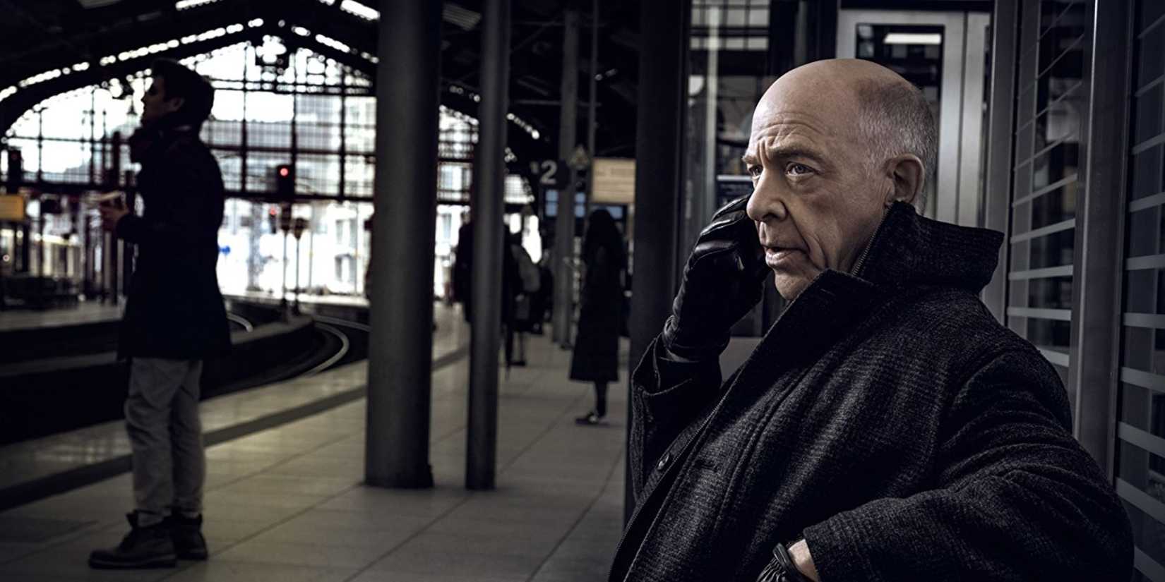 Howard Silk (J.K. Simmons) is sitting at the train station talking on the phone in 'Counterpart.'