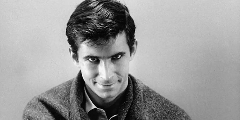 Norman Bates staring at the camera and smiling in Psycho.