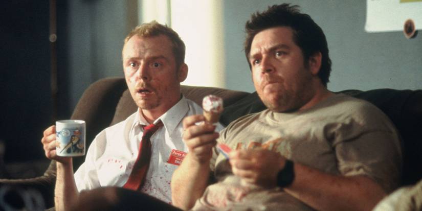 Shaun and Ed watching TV with snacks in 'Shaun of the Dead'