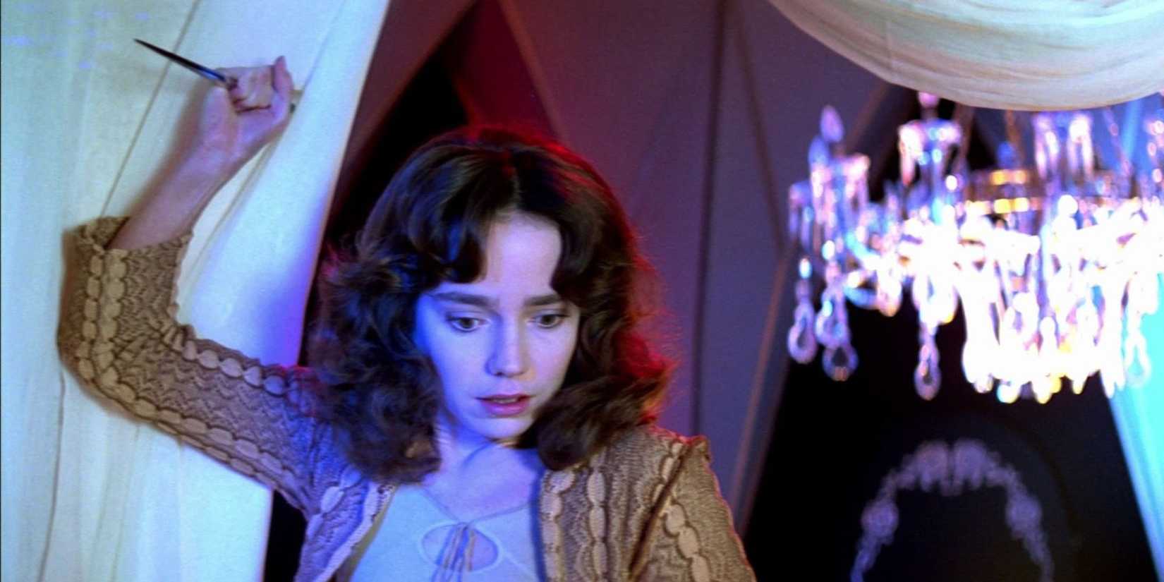 A young woman holding a blade in Suspiria 1977
