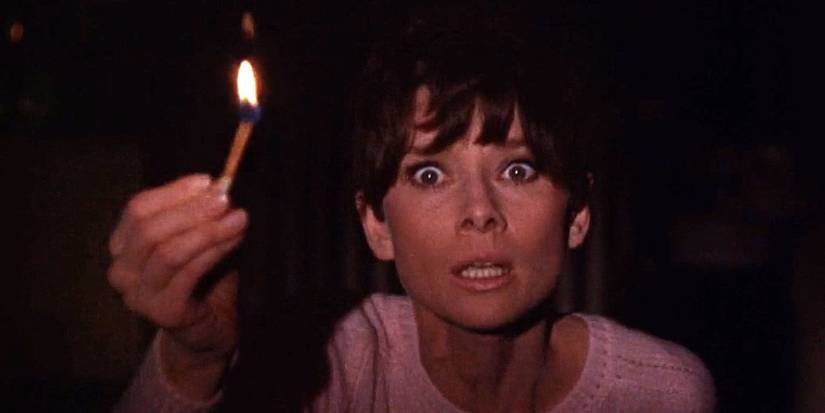 Audrey Hepburn as Susy Hendrix holding up a flaming matchstick in Wait Until Dark (1967)