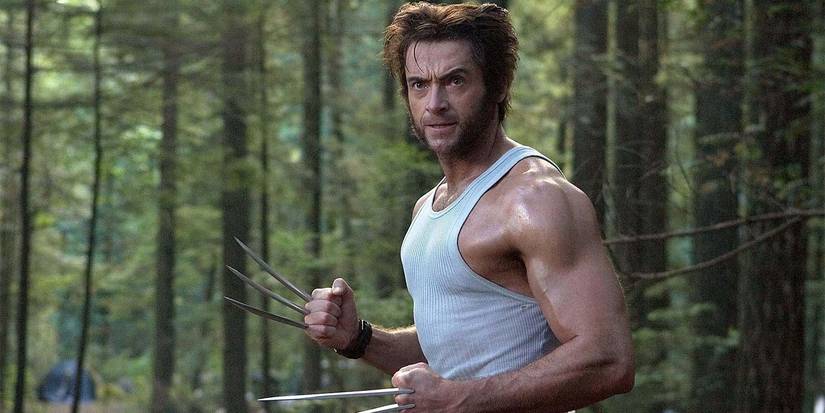 Hugh Jackman as Wolverine/Logan stands in the woods with his claws out