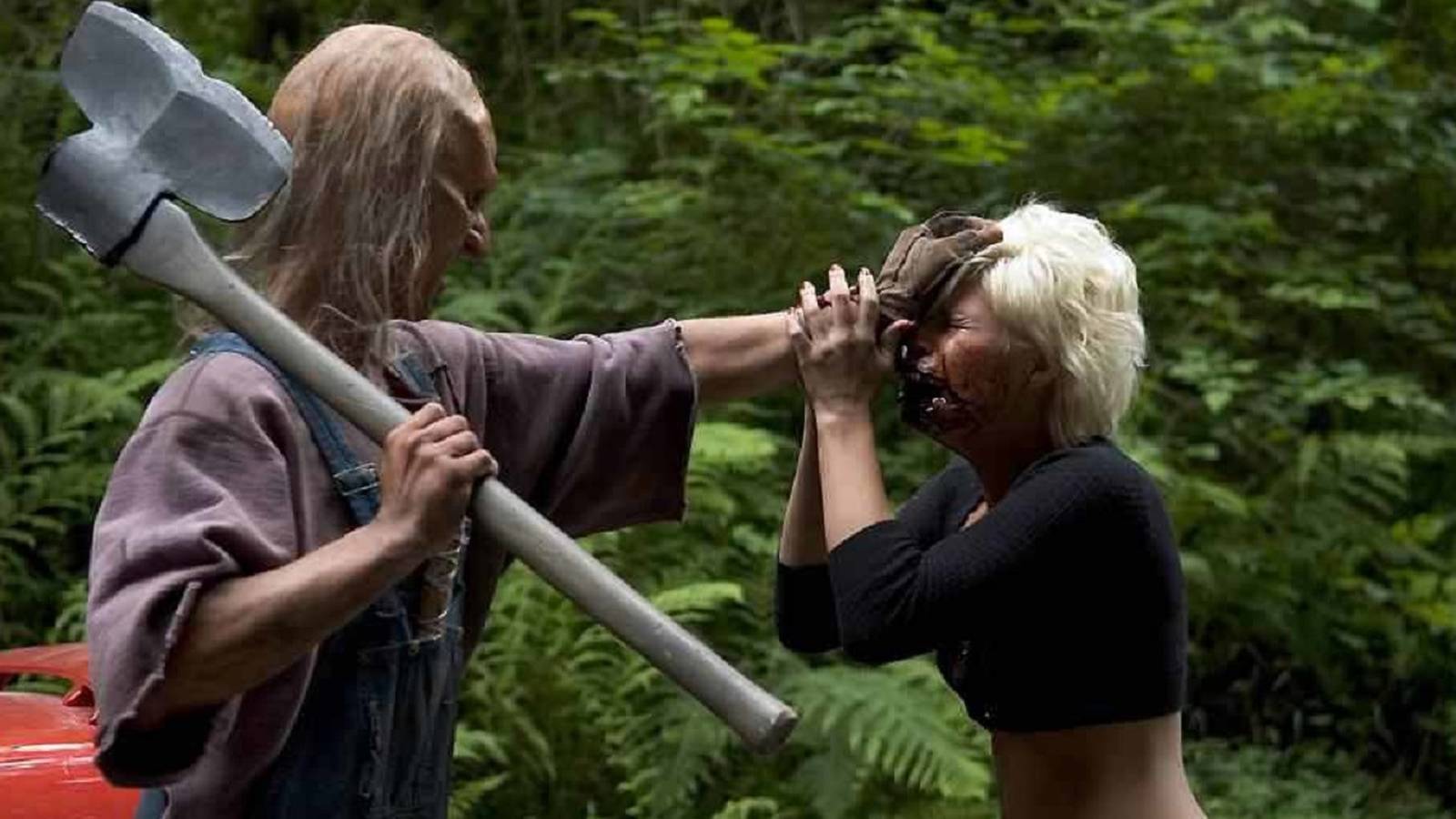 Kimberly, played by actor Kimberly Caldwell, is grabbed by the head by Three Finger, played by actor Jeff Scrutton, in Wrong Turn 2: Dead End.