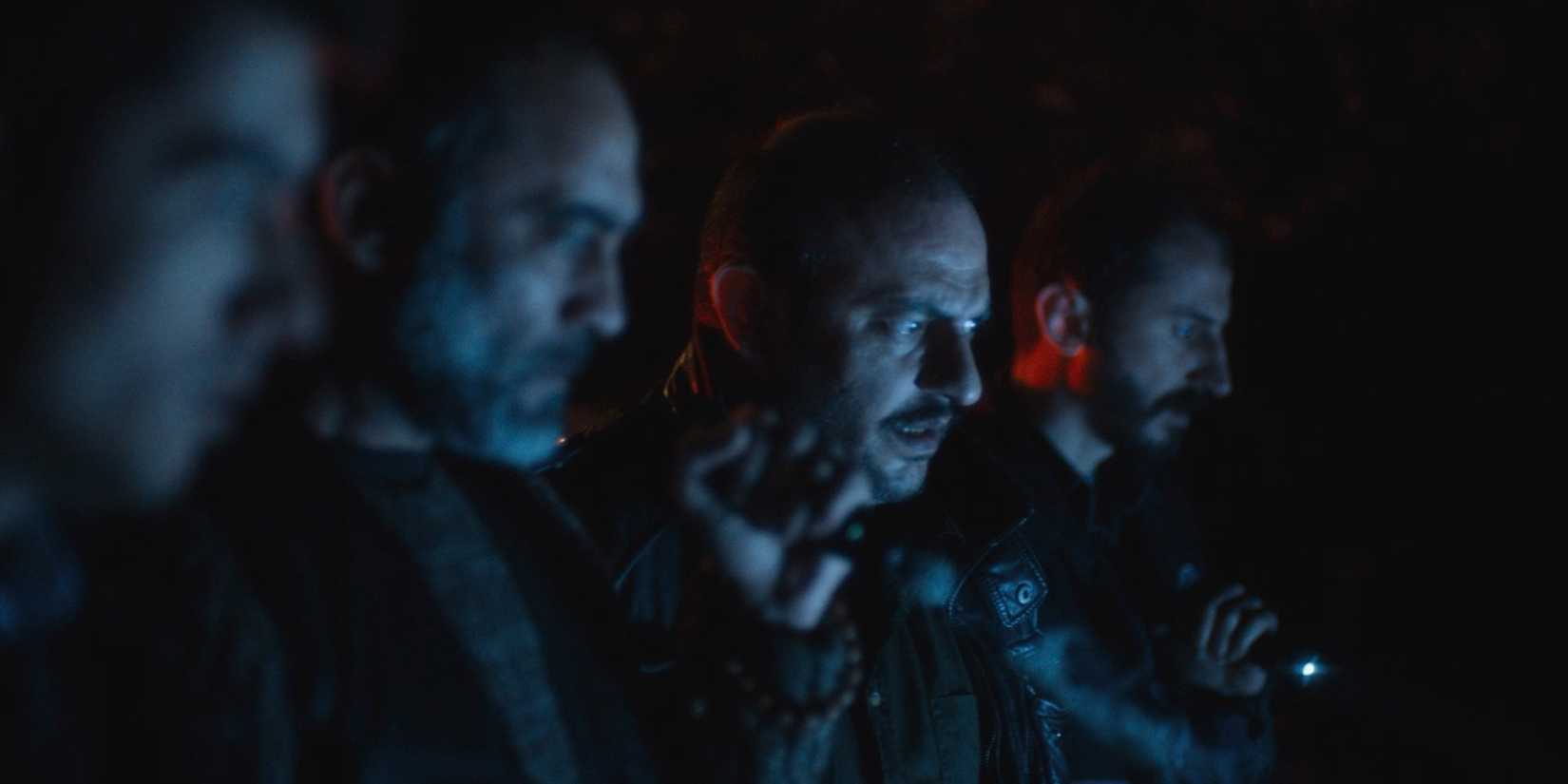 A group of frightened cops staring down in the Turkish horror movie Baskin