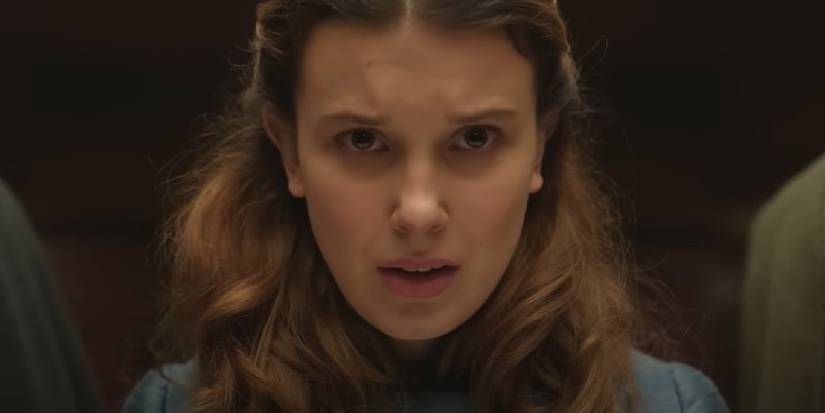 Millie Bobby Brown with a furrowed brow, looking concerned in Enola Holmes. 