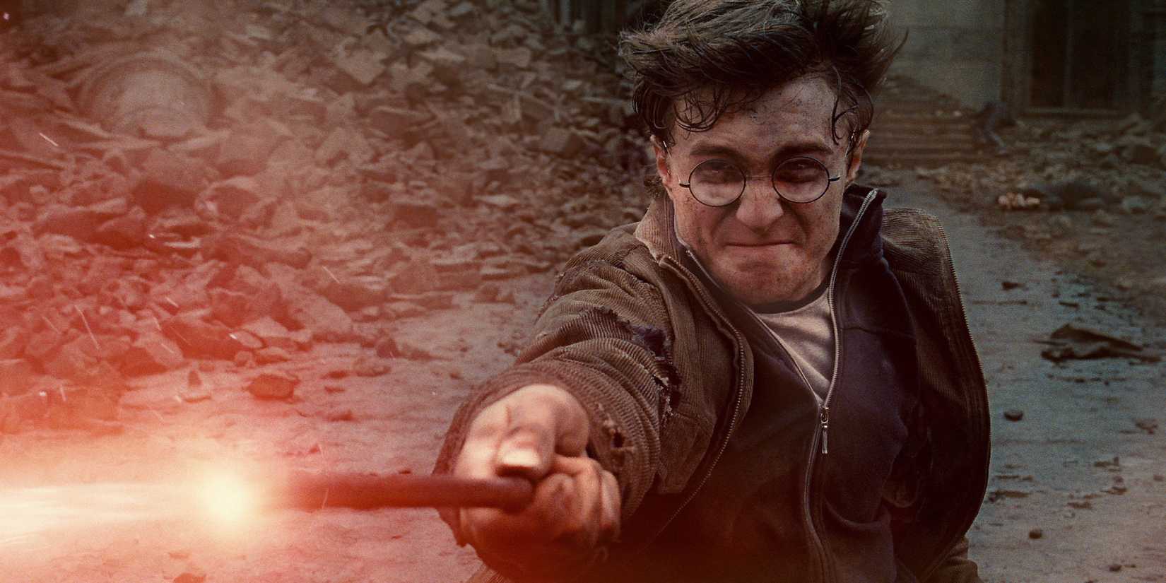 Harry Potter on the ground, shooting magic out of his wand at an off-screen Voldemort