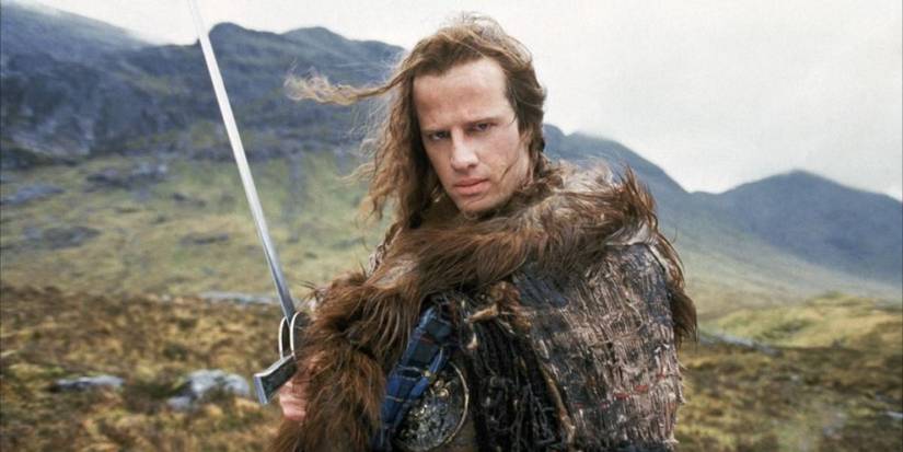 Connor MacLeod holding a sword in the Scottish highlands in Highlander
