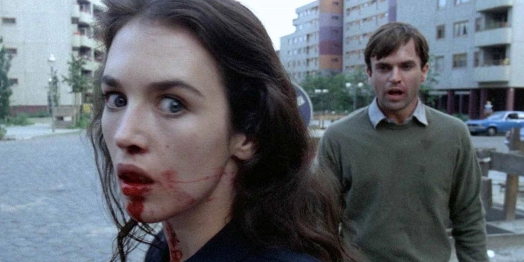 Anna with a bloody face being followed by her husband Mark in 'Possession'