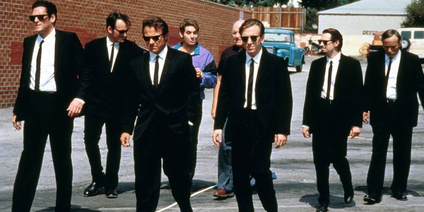 The cast of 'Reservoir Dogs' wearing black suits and walking down the street.