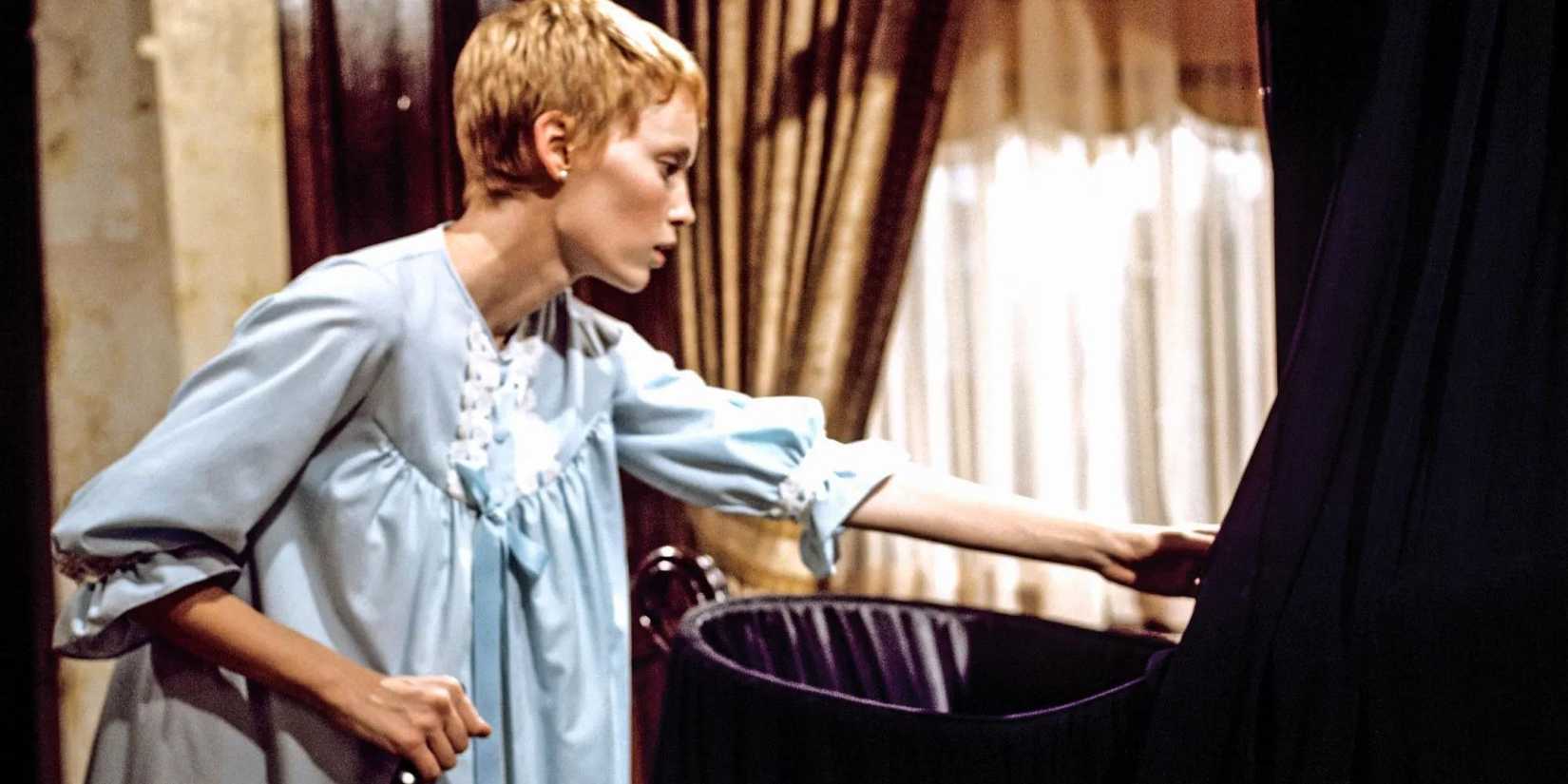 Rosemary looks over crib while holding a knife