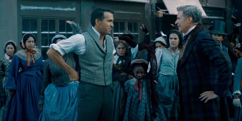 Ryan Reynolds and Will Ferrell in period costumes smiling at each other in front of a crowd in Spirited.