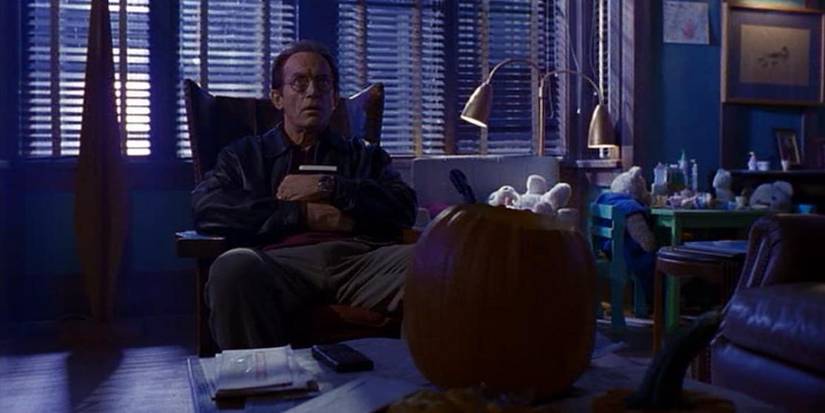 Frank Black (Lance Henriksen) sits at home alone on Halloween in the 'Millennium' episode "The Curse of Frank Black."
