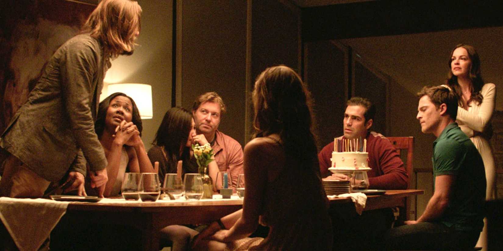 The cast of The Invitation gather around a dinner table