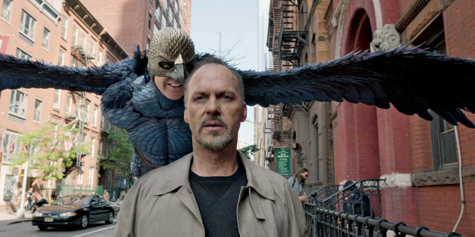 Birdman flying behind Riggan as he walks down the street in Birdman.