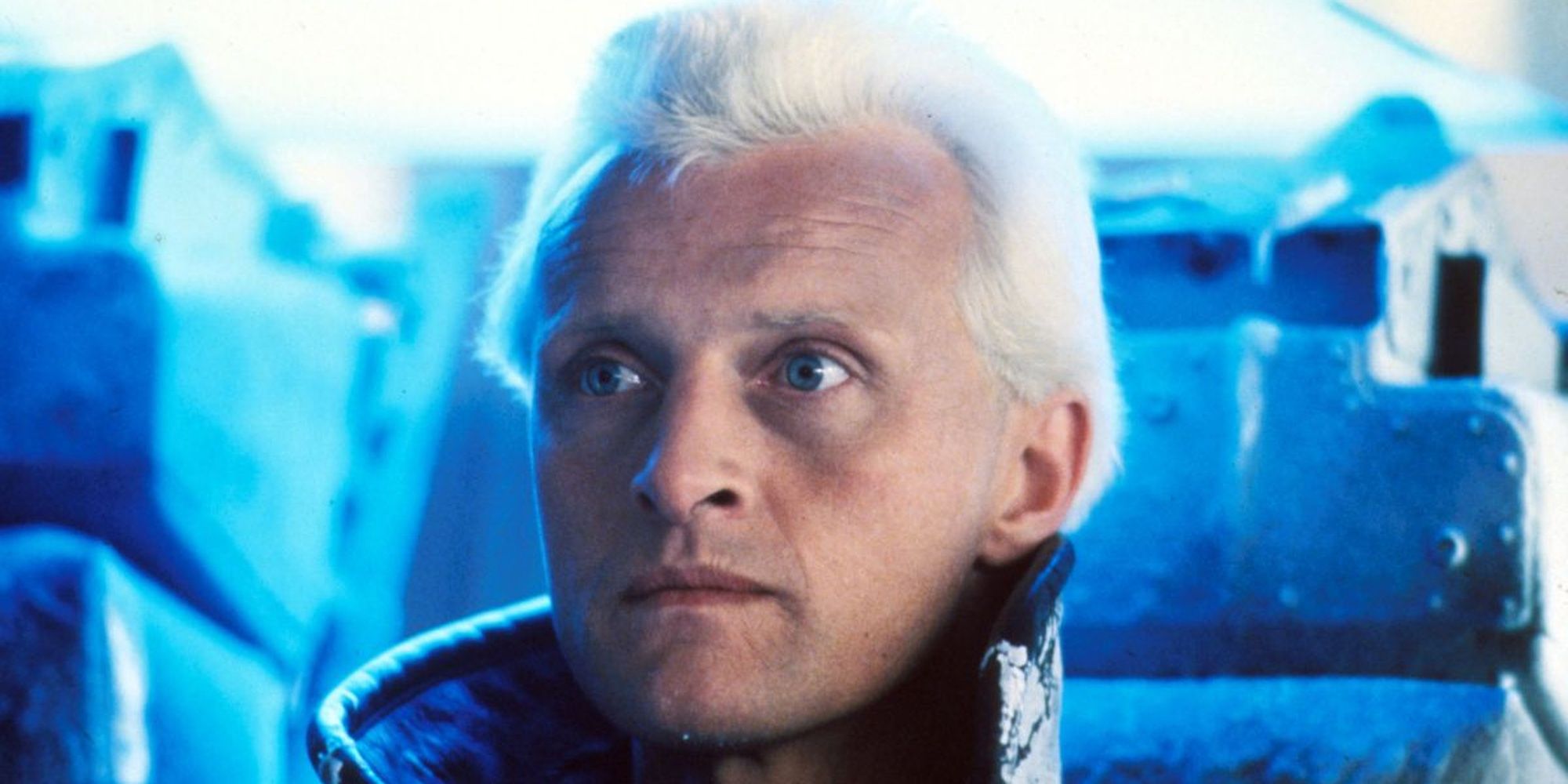 Close-up shot of Rutger Hauer as Roy Batty with white hair and a serious look in Blade Runner.