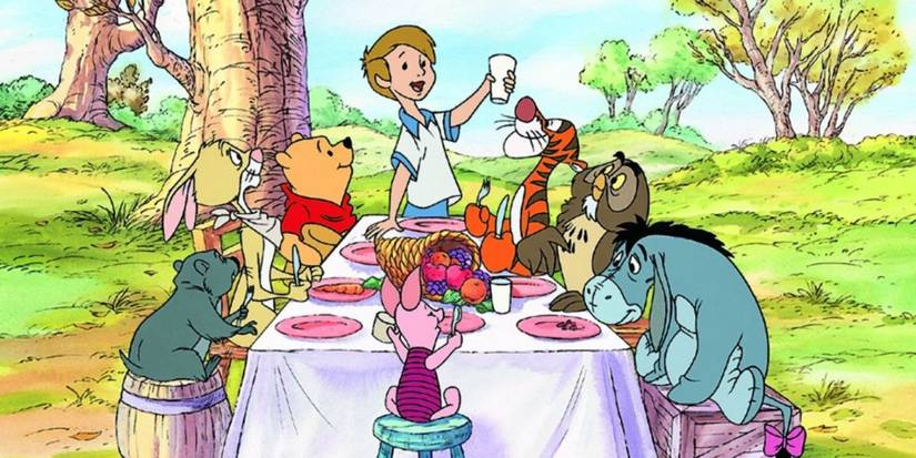 Characters from Winnie the Pooh sitting around a table having Thanksgiving