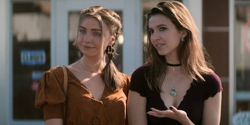 Sterling (Maddie Phillips) and Blair (Anjelica Bette Fellini) smiling in the series Teenage Bounty Hunters.