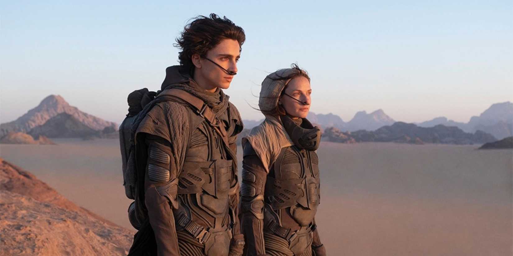 Paul and Jessica in the desert looking to the distance in Dune.