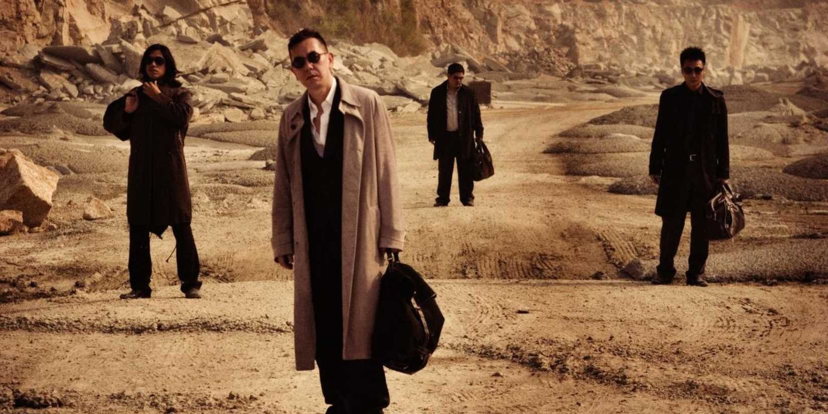 Several men standing in the desert in Exiled
