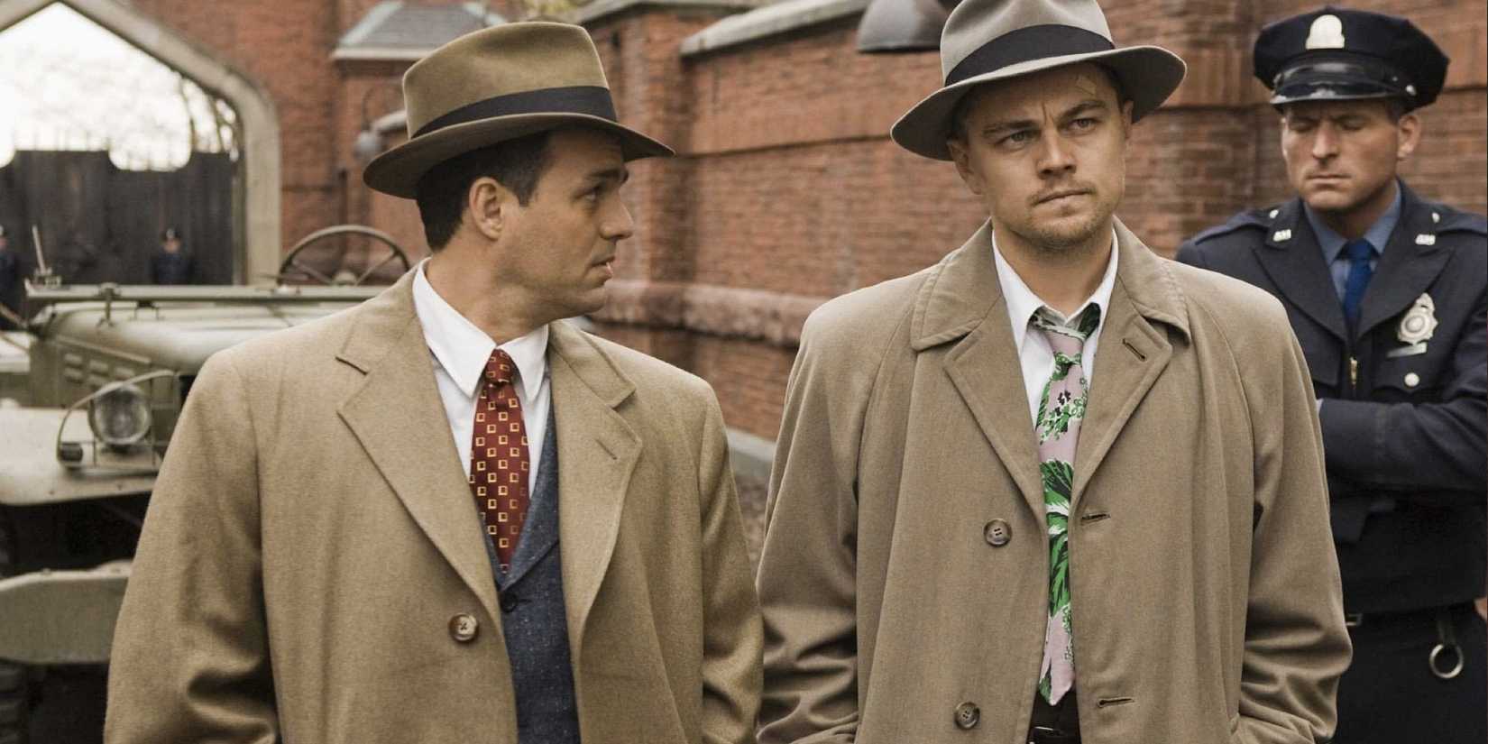 Teddy and Chuck walking side by side outside an asylum in 'Shutter Island'