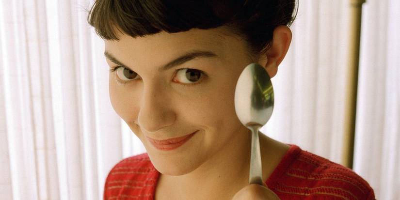 Audrey Tautou in 'Amélie' holding a spoon and smiling.