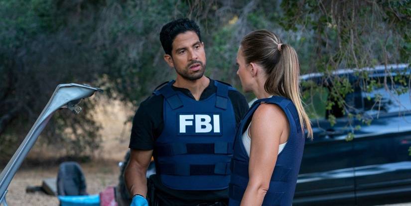 A man with an FBI vest talks to a woman in a scene from Criminal Minds.
