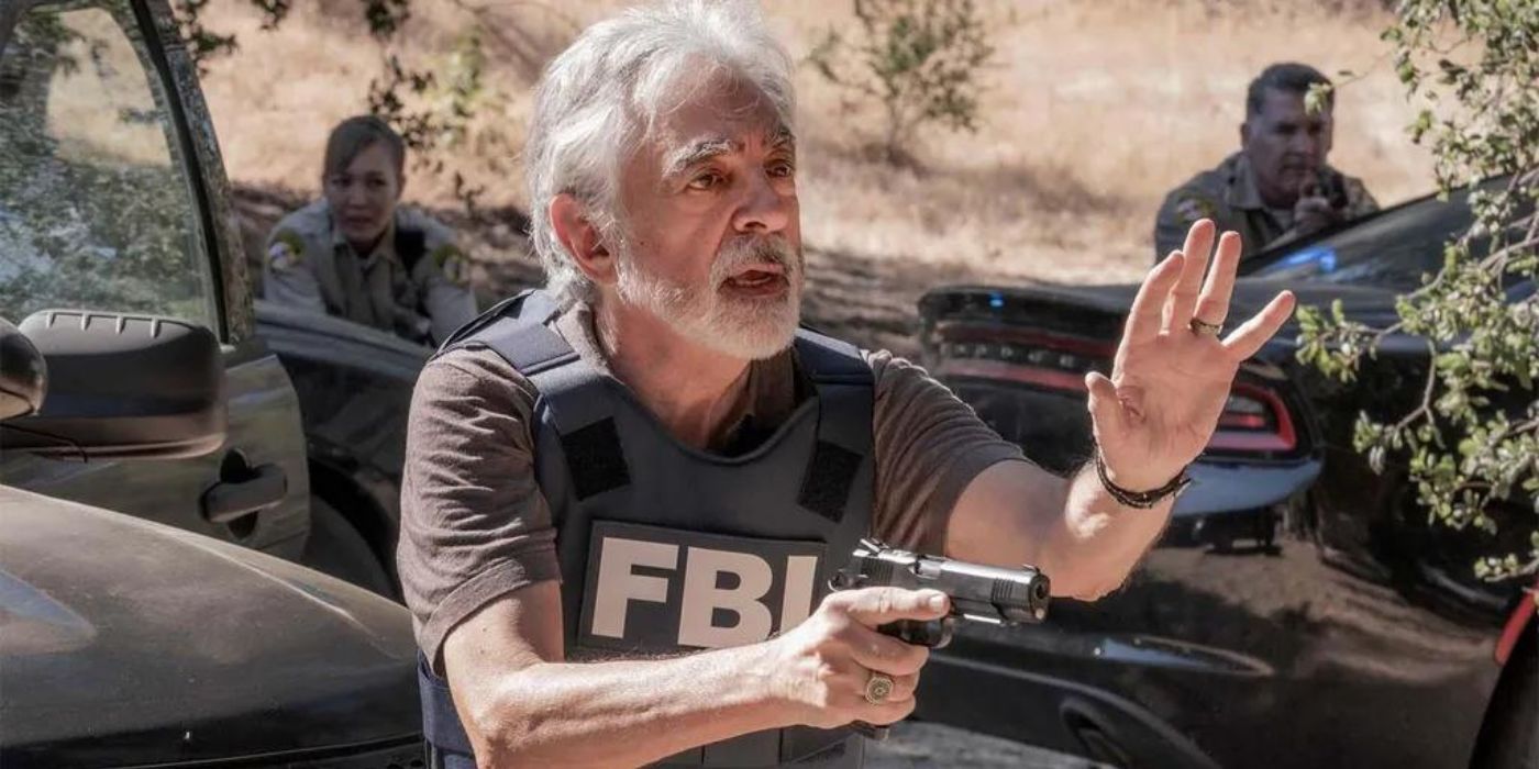 Joe Mantegna as David Rossi with a gun in the field in Criminal Minds