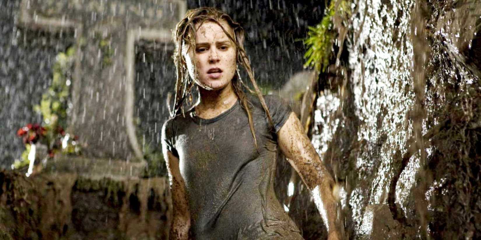 Drag Me To Hell's Christine Brown standing in a grave in the rain.