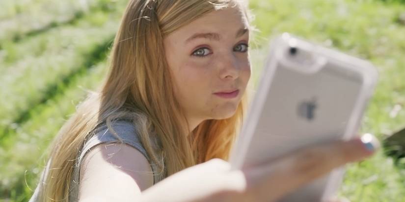 Elsie Fisher como Kayla tirando uma selfie na oitava série